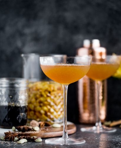 a cozy chai cocktail with golden raisin-infused spiced rum & homemade vanilla chai simple syrup. this chai cocktail is just as perfect for a cozy date night in as it is for celebrating with friends & loved ones this winter season. the perfect cozy winter nightcap. cheers! #playswellwithbutter #chai #rum #hygge #datenightathome #cocktail #cocktailrecipe #wintercocktail #winterdrink #cozycocktail #cozy