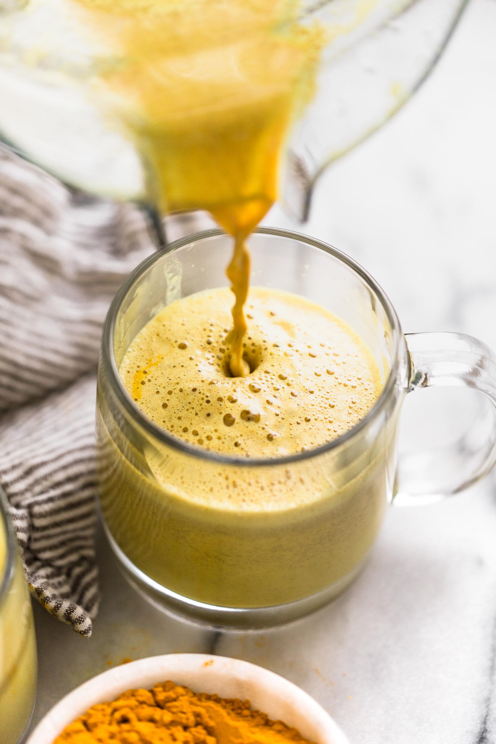 an easy golden turmeric latte recipe that’s just as delicious as it is beautiful! this easy golden turmeric latte is loaded with the warm flavors, antioxidants and anti-inflammatory benefits of turmeric, ginger, and cinnamon. great for a calming morning drink, or an afternoon pick-me-up! #goldenlatte #turmericlatte #healthycoffeerecipe #healthybreakfast #homemadelatte #playswellwithbutter